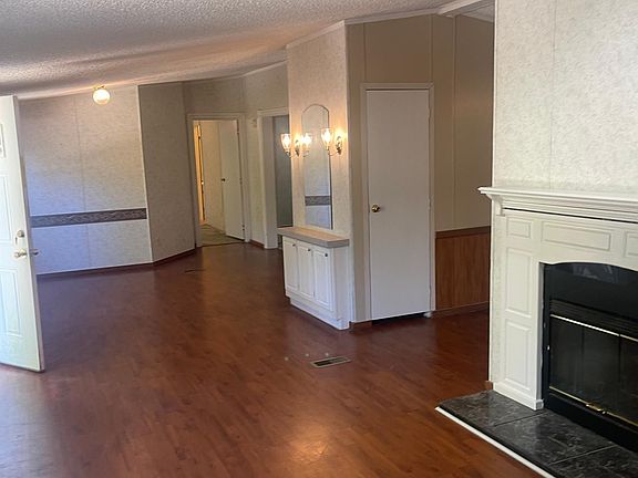 other end of walk in living room view of back bedroom from hallway