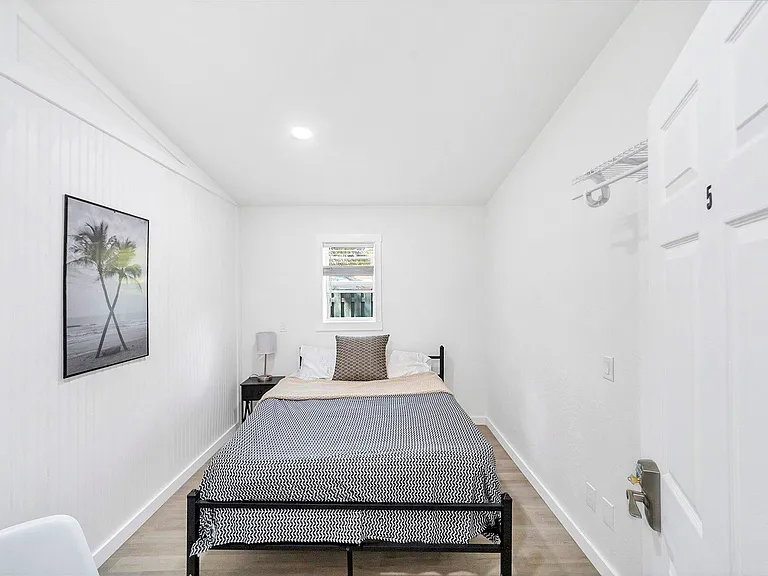 Cozy 100 square foot plus bedroom with workstation and Queen size bed.