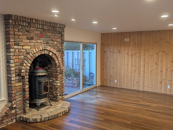 Romantic fireplace with historic brick work and bamboo floors throughout the house