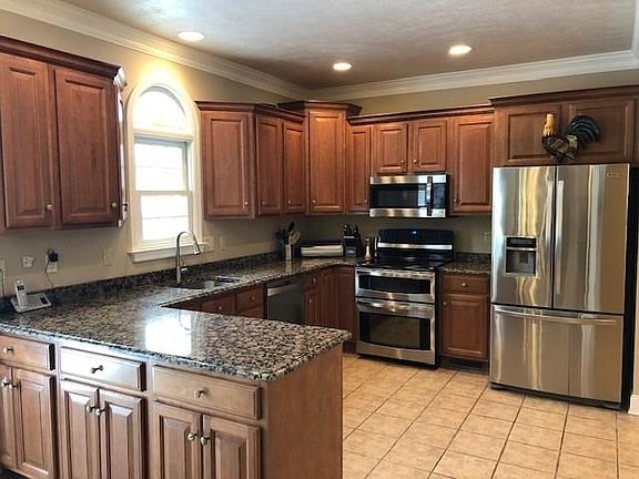 Updated Kitchen with Maple Cabinets and Granite Countertops.