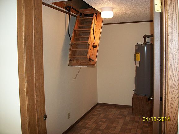large utility room with attic storage, new water tank, and w