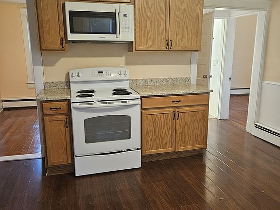 Kitchen with Thomasville cabinets, range and microwave.