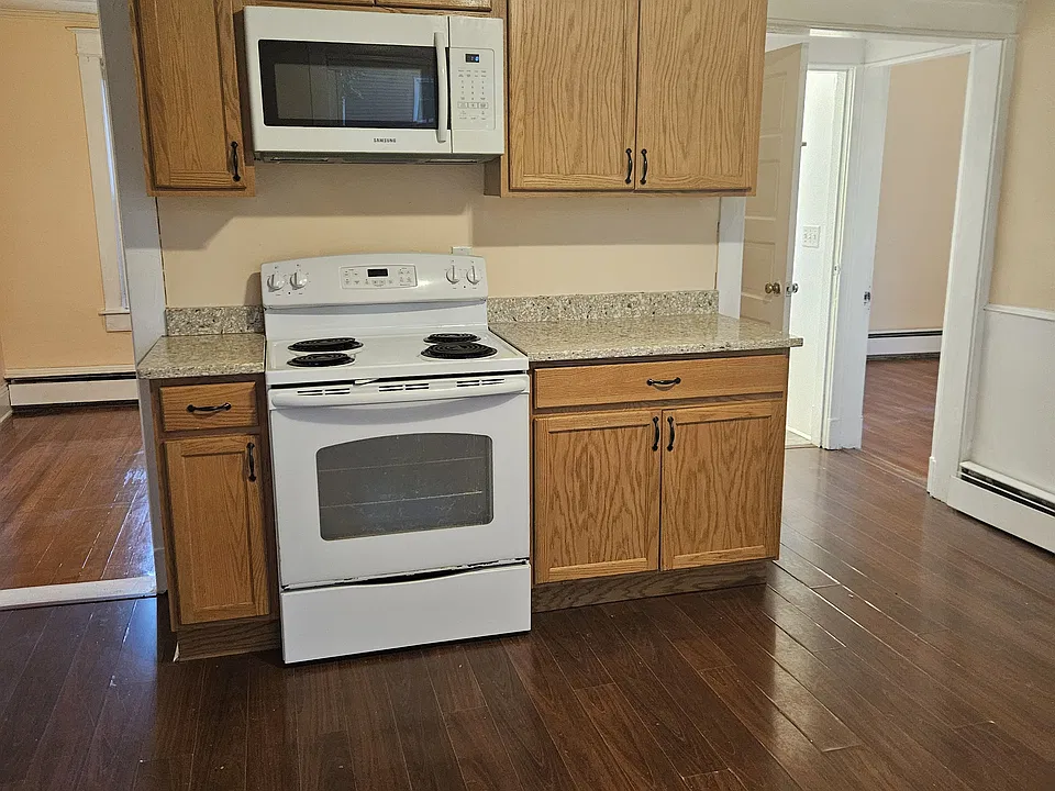 Kitchen with Thomasville cabinets, range and microwave.