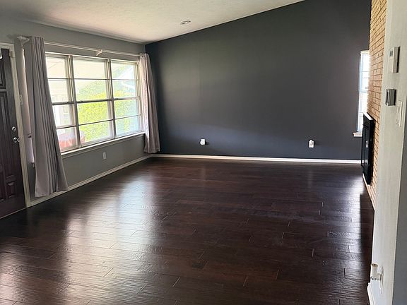 Formal living room with fireplace, vaulted ceiling, and recessed lighting (with dimmer feature)