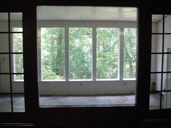 huge sun room overlooking back wooded acreage