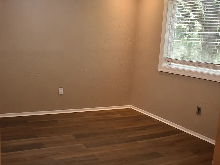 Comfortable Primary bedroom with ample closet space and peaceful wooded views.