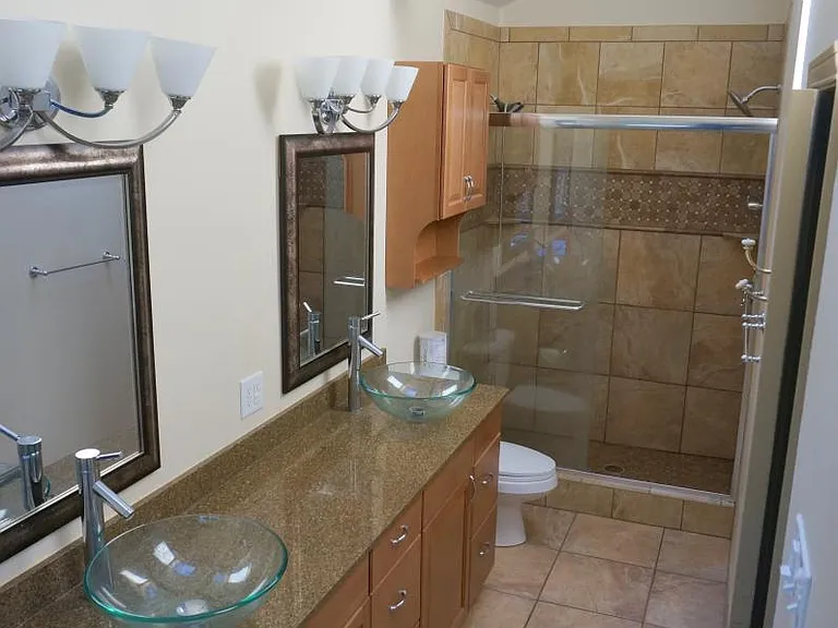 Master bathroom has a shower on the other side with 2 shower heads
