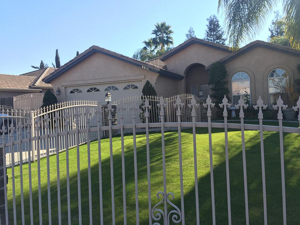 This is the front yard....please note the wrought iron fencing, beautiful yard, and outside lighting leading to the front door.