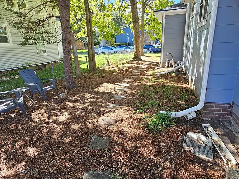 Side yard with Flowers and Adirondack chairs