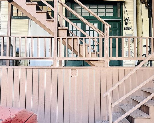 Steps up to front door of unit with deck space