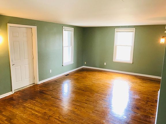 Front door and windows look out over spacious covered front porch.