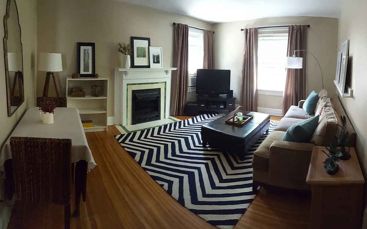Spacious living room area with beautiful hardwood floors and decorative fireplace. - 36 Avondale Park #2