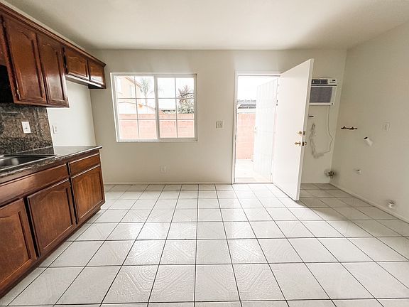 View of exterior back door leading to private backyard patio.