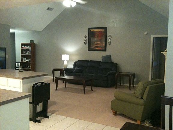 Living area features vaulted ceiling & updated ceiling fan