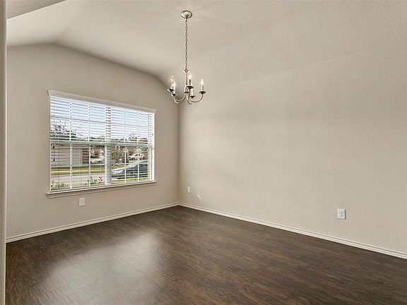 Formal dining has pretty laminate floors and tall ceiling.