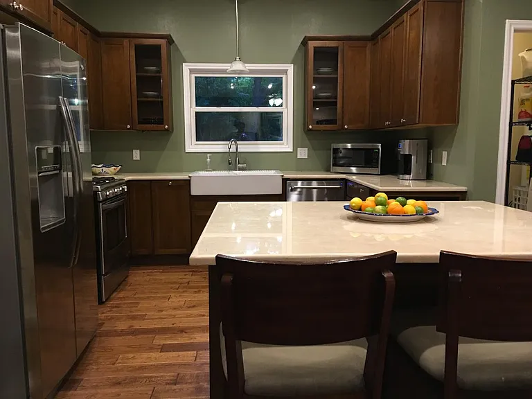Kitchen with stainless steel appliances, gas range and marbl
