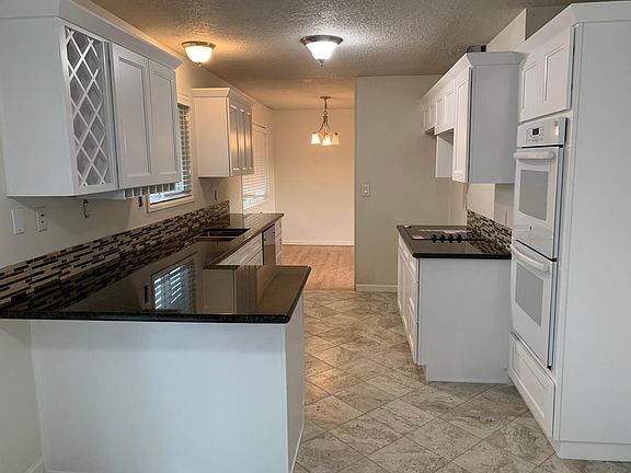 Double ovens, side by side fridge, newer dish washer, sink, granite and cabinets.