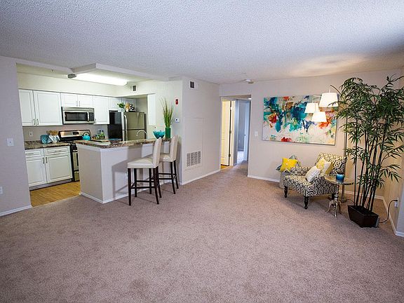 Open floor plans layout with plush carpeting and kitchens with breakfast bars.