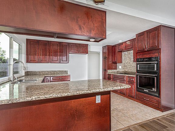 Bar seating, granite counters, gas stove top.