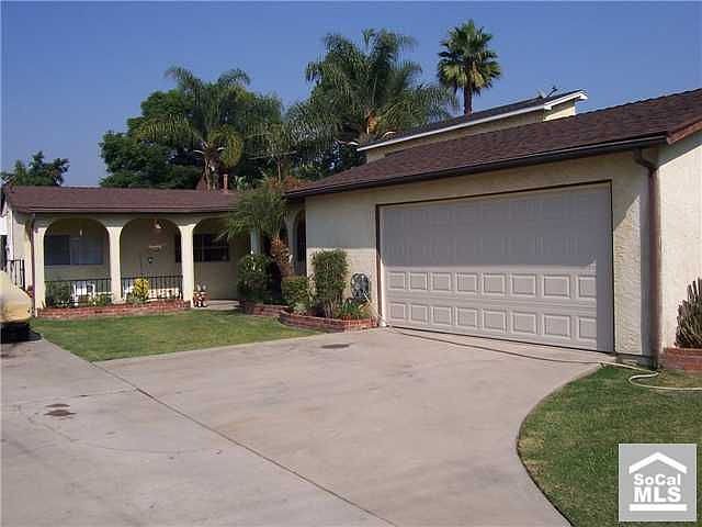 Front view. Large driveway leads to RV access