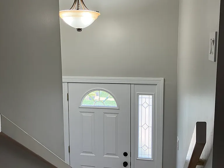 View of front door area from top of main level stairway