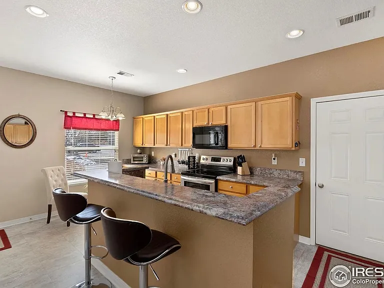 Large kitchen with doorway to attached 2-car garage shown on right.