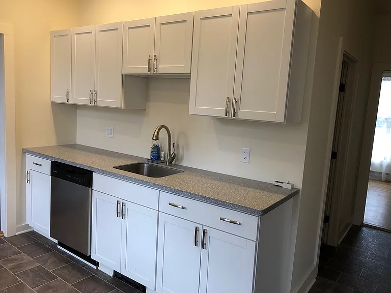 Plenty of cabinets for storage, electric dish washer, and in