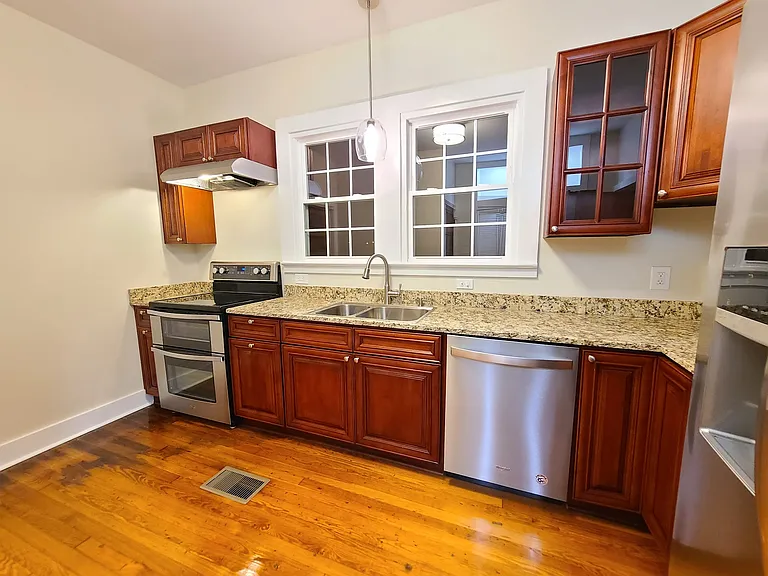 Kitchen w/ new cabinets, granite counters, electric ss stove/oven, ss overhead stove light/vent, ss dishwasher, ss double sink, garbage diposal, and ss french door refrigerator.