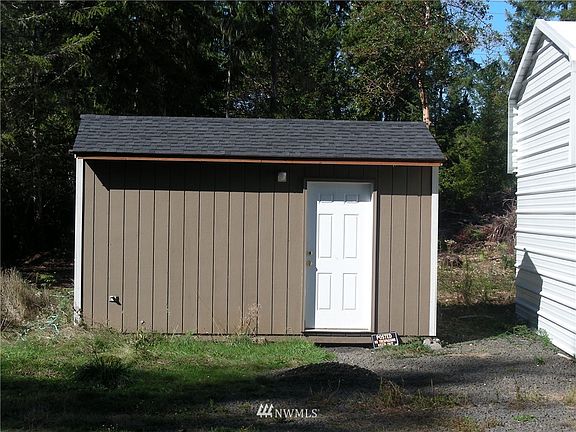 Large pump house with well pressure tank and plenty of additional storage.