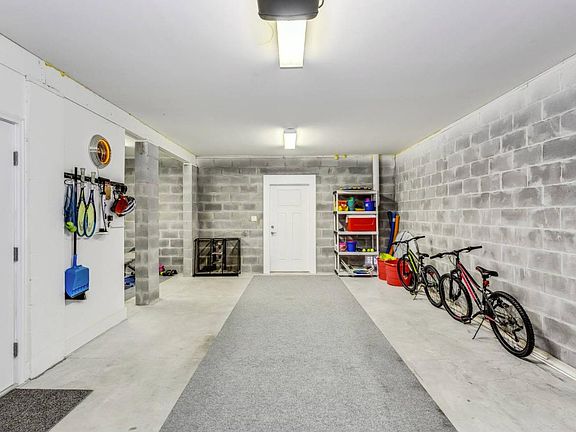 Enter into the spacious ground level garage with rear access to the bbq patio, side personal gym, and storage closet