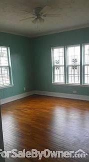 Living Area
						:
						Original wood floors in the living area and New windows throughout
