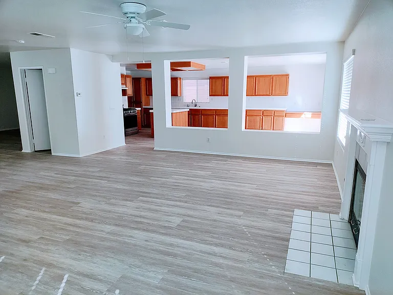 Family Room with view into the kitchen, and entrance to the downstairs half bathroom