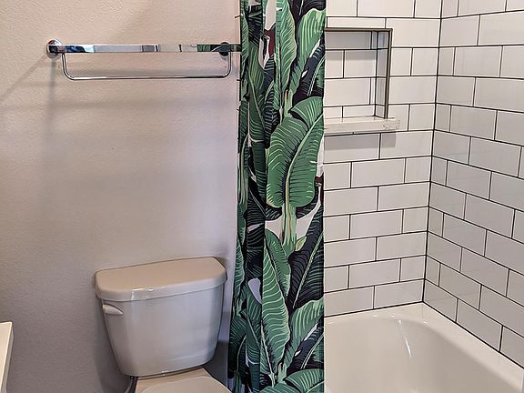 The tiled showers are spacious and inviting. The small window up above helps provide natural lighting.