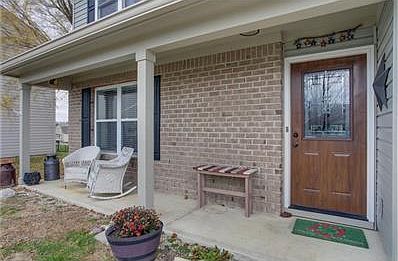Front entrance has covered porch and beautiful new front door.