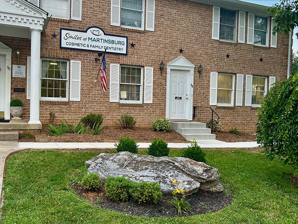 Photo shows front door and front second-story windows of apartment