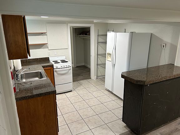 Kitchen looking back into the hallway to bedroom. Closet on right.