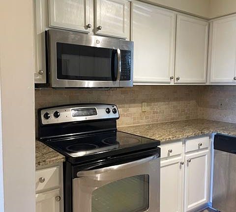 Kitchen appliances and tile floors.