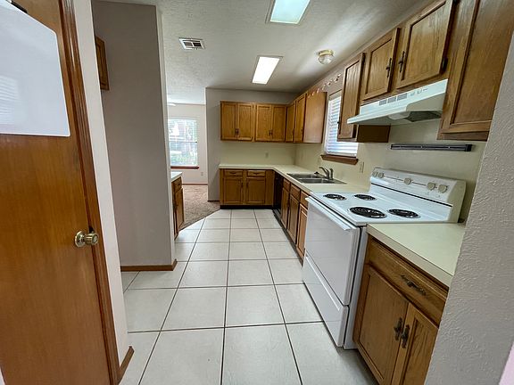 Full kitchen with electric stove, dishwasher and pantry closet