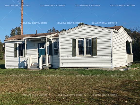 House with large yard is located in quiet neighborhood.