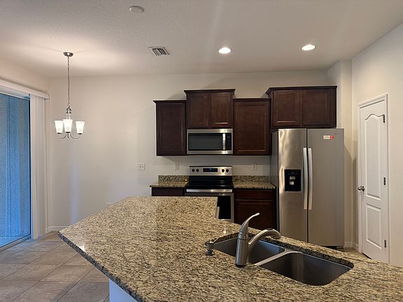 Gorgeous kitchen with stainless steel appliances, large granite counter-tops, nice cabinets and plenty of space in the built-in pantry
