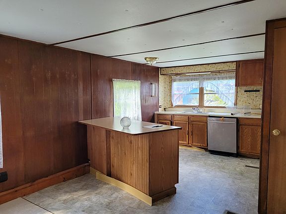 Dining room/ Kitchen view. (There is no dishwasher. Previous tenants removed it. I will not be purchasing another one. ) Pantry on right.