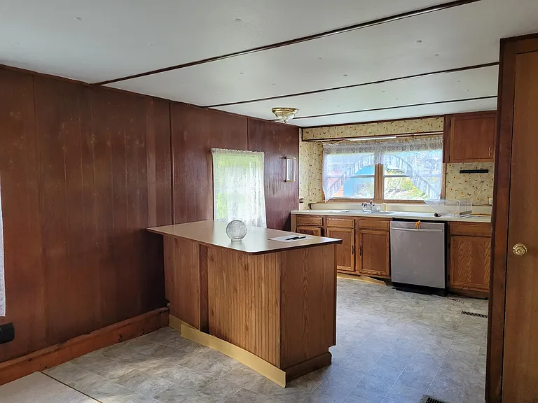 Dining room/ Kitchen view. (There is no dishwasher. Previous tenants removed it. I will not be purchasing another one. ) Pantry on right.