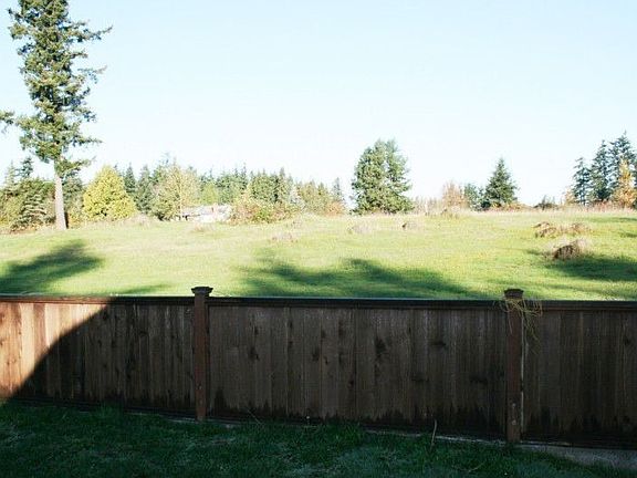 Fully fenced back yard. This home backs up to a delightfully private fields and forests