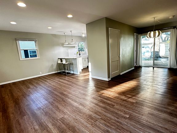 Open concept living room and kitchen with separate dinning space.