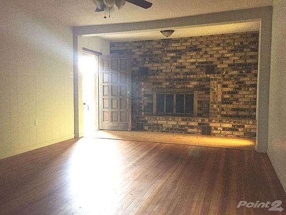 Living area with fireplace. Nice hardwood floors