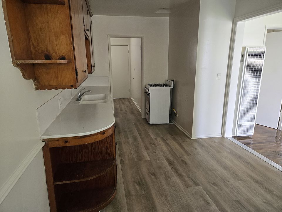 Solid wood cabinets, large counter top, Laminate flooring, dining area