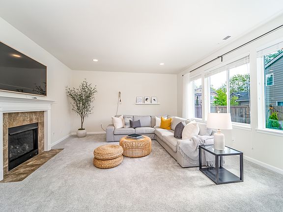 Family room with bank of windows overlooking backyard