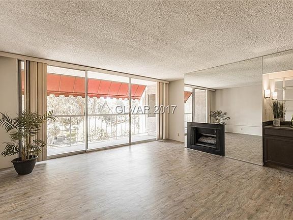 Spacious living room with its new vinyl plank wood tone flooring. Enjoy the warmth of the gas firepl