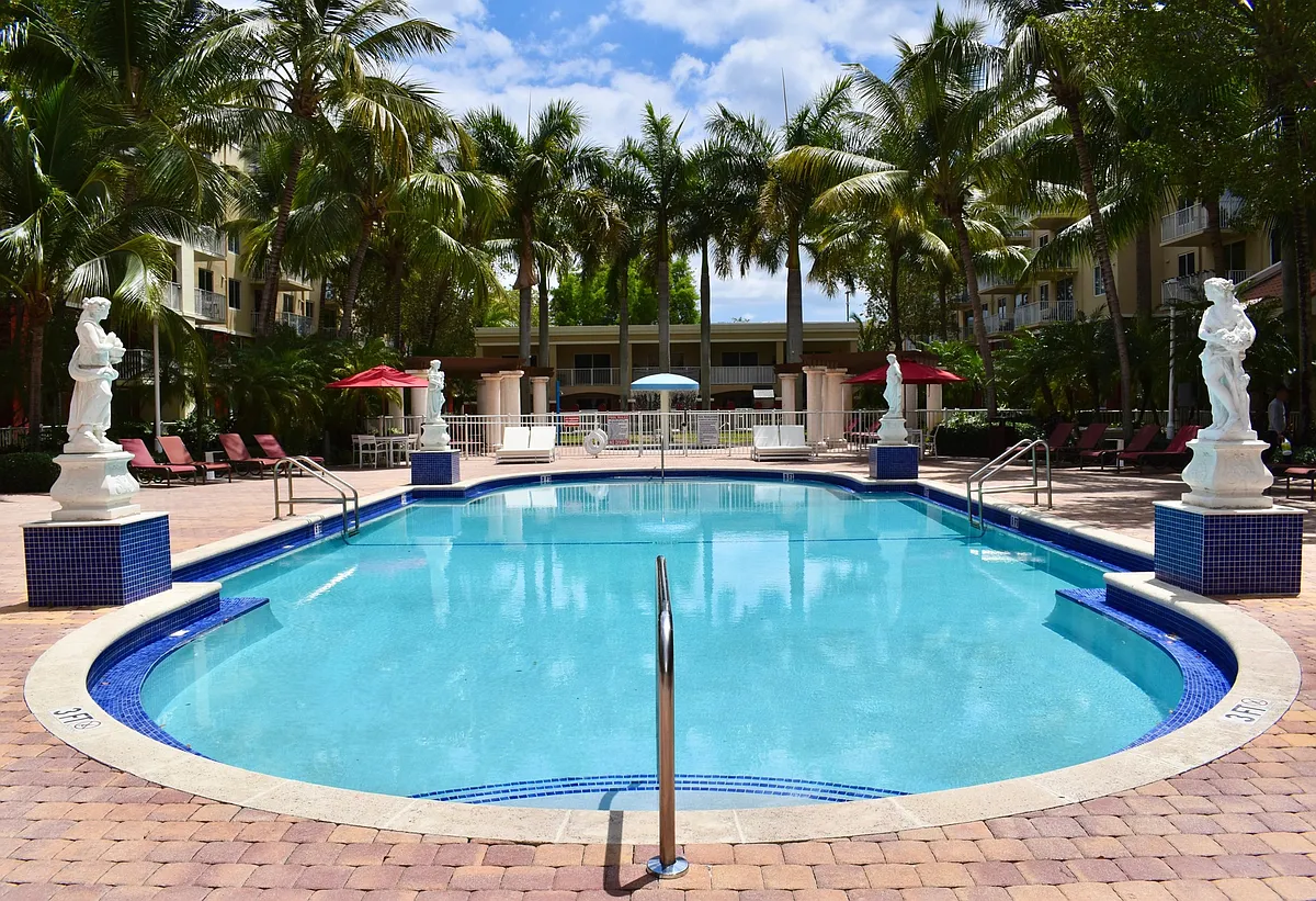 Take a dip into our Refreshing Swimming Pool! - Country Club Towers