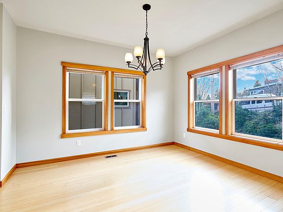 Located off the foyer, the formal dining room with chandelier, gleaming bamboo floor and plenty windows, makes a lovely statement and can host all your dinner parties in style!